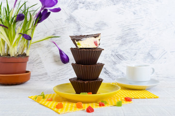 Delicious and healthy cottage cheese dessert with nuts and candied fruits in chocolate glaze.