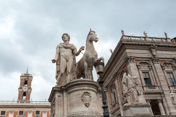 Fototapeta na wymiar Statue of Castor at the Cordonata Stairs to the Piazza del Campidoglio Square at the Capitoline Hill in Rome