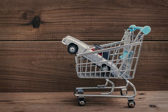 shopping cart with car, concept of buying car