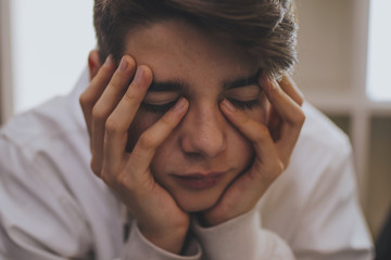 thoughtful young portrait with his hands on his face