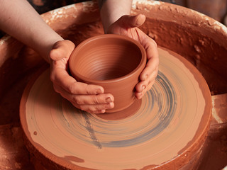 production process of pottery. A cut of a clay cup from a potter's wheel.