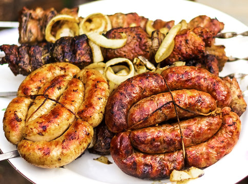 Grilled sausages and roast meat cooked on fire