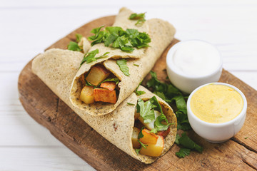 Vegetarian masala dosa with potato, chutney and sambar sauces.