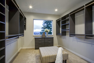 Spacious walk-in closet with clothes rails and shelves.