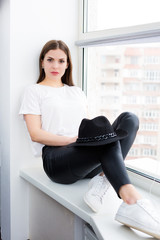 Beautiful woman sitting by the window