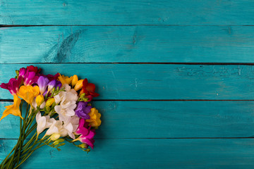 Bouquet of freesia flowers on a wooden background