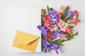 beautiful floral bouquet, blank card and envelope on grey