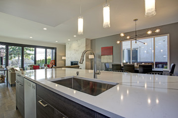 White and gray kitchen room interior with open floor plan.