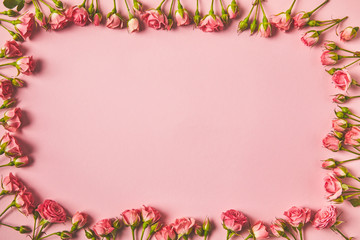top view of frame made from beautiful pink roses and copy space on pink