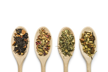 variety of tea blend on wooden spoon on white background