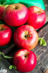 ripe red apples on wooden background