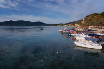 Fototapeta na wymiar Agios Sostis, Zakynthos Island, Greece – September 24, 2017: Boats in Laganas harbor on a summer cloudy day.