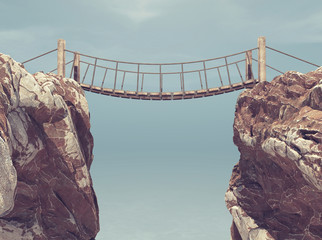 Old bridge over between two big rocks.