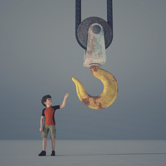 Little boy reaching a crane hook