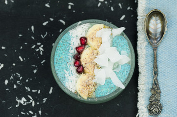 Breakfast blue spirulina smoothie bowls and chia pudding topped with fresh fruits