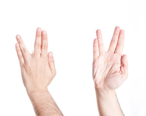 Hands gesturing Vulcan salute, on white background.