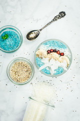 Breakfast blue spirulina smoothie bowls and chia pudding topped with fresh fruits