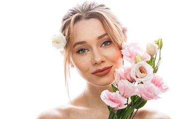 Obraz na płótnie Canvas Picture of elegant woman 20s with amazing makeup holding bunch of lovely tulip gentian flowers, isolated over white background