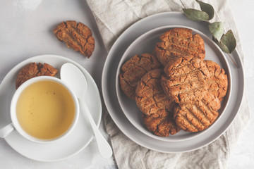 Homemade healthy aquafaba vegan cookies with tea, top view, copy space. Vegetarian food concept.