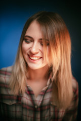 Fototapeta premium portrait smiling girl on blue background in studio