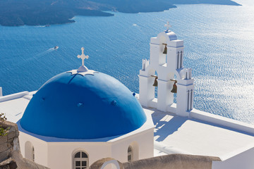 The Three bells of Fira and blue dome, Santorini, Greece.