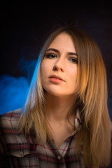 portrait smiling girl on blue background in studio