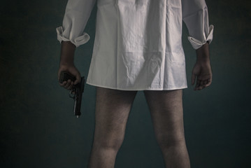 Man without pants holding a gun. Gun violence, male dominance, rape concept