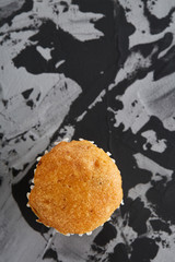 Tasty muffins arranged in pattern on light textured background, close-up, shallow depth of field, selective focus.