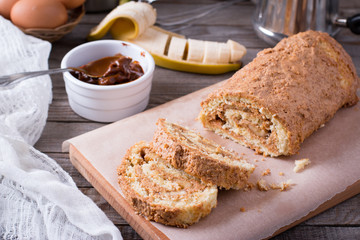 Homemade sweet biscuit roll with cream and banana