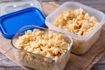 A container with frozen food on a wooden table. Ready meal