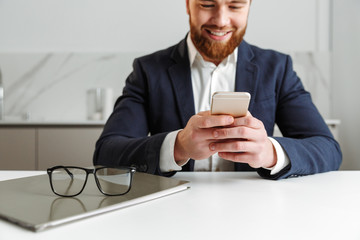 Cropped image of a happy young businessman dressed in suit