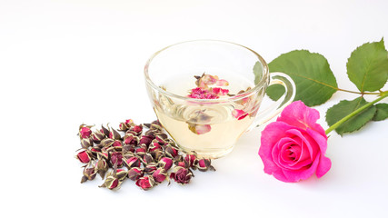 A cup of tea pink rose on a white background.