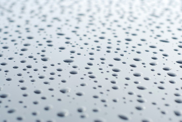 Abstract of Water Rain Drop on Car Glass, Drops over Black Shinny Background.