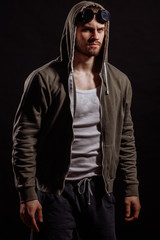 brutal biker in casual clothers with glasses on his forehead. serious man.