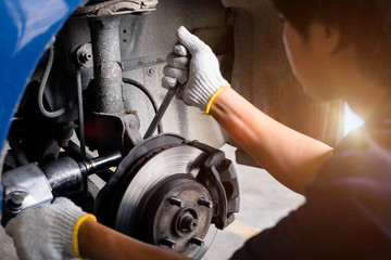 Selective focus disc Shock absorber on car, in process of new Shock  replacement, Car repairing in garage