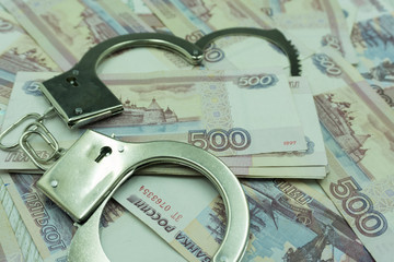 the concept of Finance or crime - handcuffs dollar and ruble .
