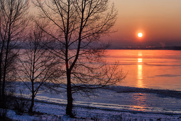 Colorful sunrise over tree and lake