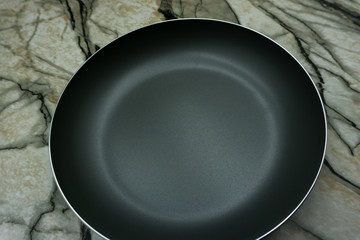 black fry pan over white background .