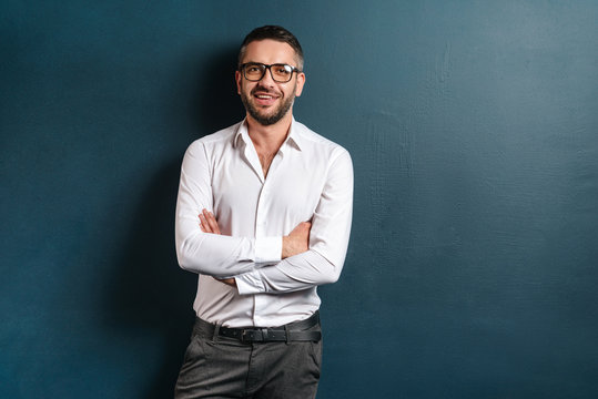 Handsome Cheerful Man Standing Over Dark Blue Background