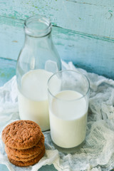 oat cookies and milk on blue wooden background