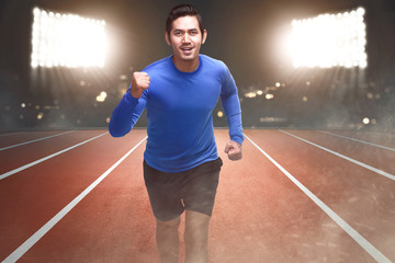 Obraz premium Spiritful asian athlete running on the track