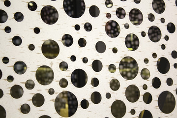 bright metal surface with round holes. abstract background