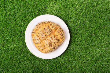 Bread on the plate on the green grass