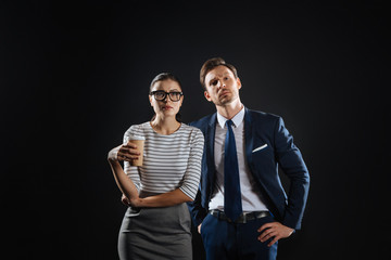 Serious question. Deep occupied responsible colleagues standing in the spacious room looking straight and thinking.