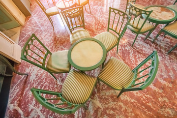 Top view of a green wooden table with chairs