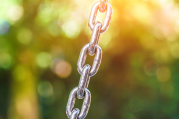 Part of a metal chain on a green background