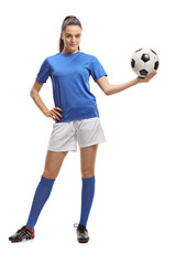 Naklejka premium Female soccer player holding a football