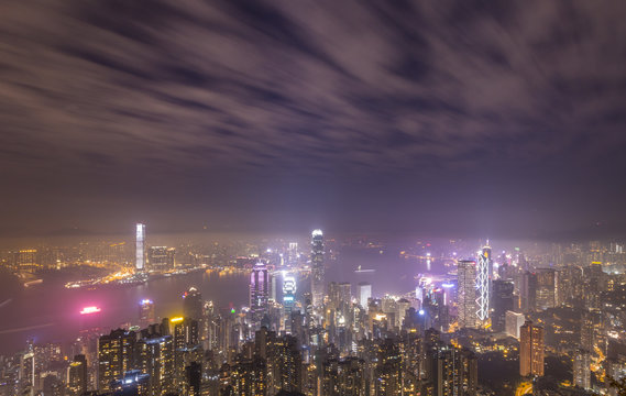 Panoramic Aerial View Of Illuminated Hong Kong Skyline And Victoria Harbour At Night. Long Exposure