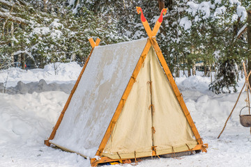 tent wigwam in winter forest © IKvyatkovskaya