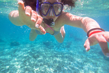 Fototapeta premium Young woman snorkeling in the tropical water of Mexico